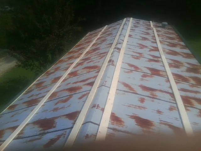 Rusted metal roof panels with new wood purlins before replacement — Storm Damage Roof Repair in Bingen by Roofing Brothers