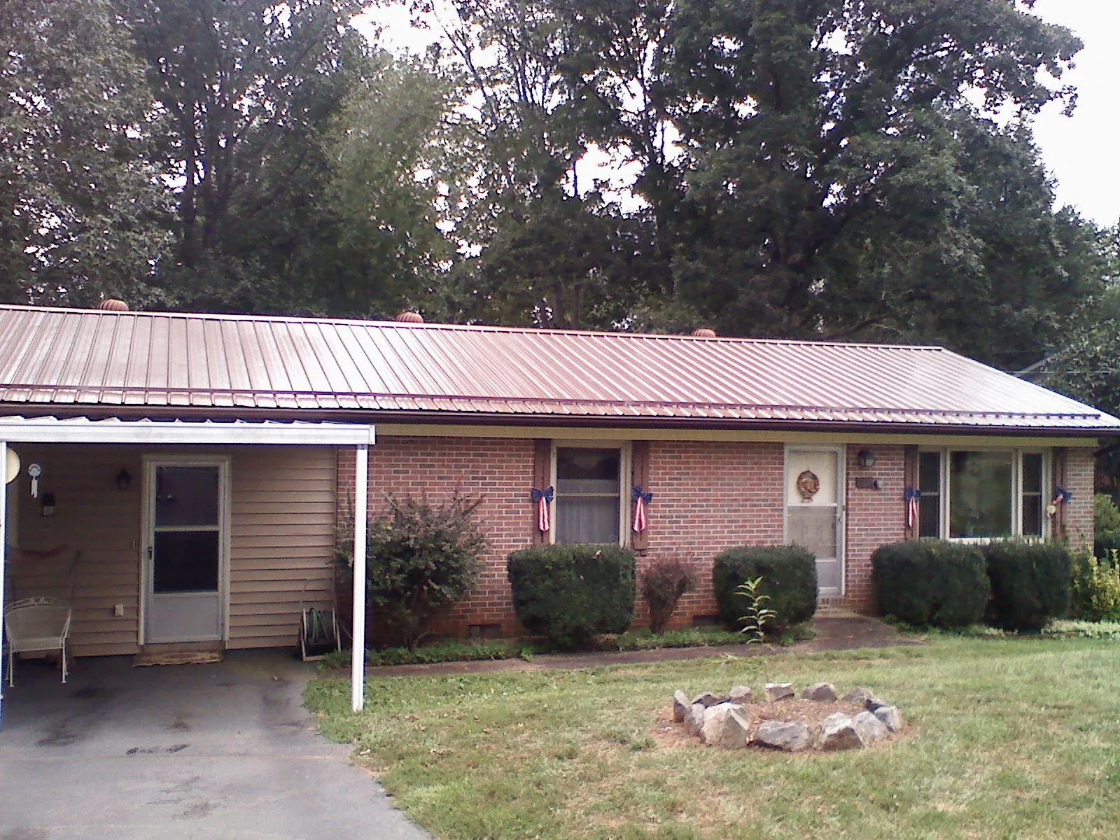 Bronze metal roof and carport on a brick ranch home — Roof Repair work by our crew in Bingen
